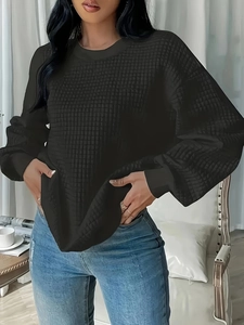 Women's black waffle knit sweatshirt with a crew neck and relaxed drop shoulder fit