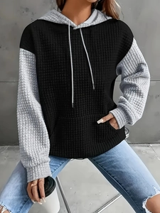 Women's black and grey color-block hoodie with waffle knit texture and kangaroo pocket