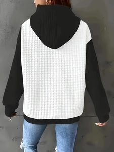 Detail of color-block hooded sweatshirt with white waffle texture stitching on the back