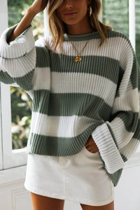 Detail of green and white wide striped knit sweater with ribbed texture and drop shoulders
