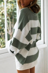 Detailed macro view of heavy-knit fabric texture on striped lantern sleeve sweater