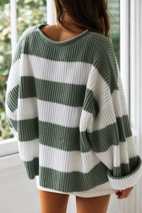 Back view of a green and white striped knit sweater with oversized roll-edge detail