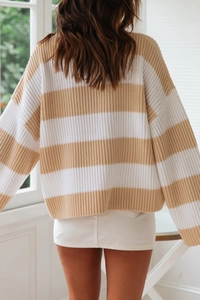 Detail of the back view of a loose striped knit sweater with drop shoulder design