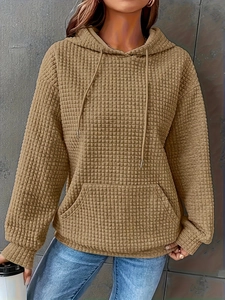 Detail of khaki waffle knit hoodie with drawstring hood and front kangaroo pocket
