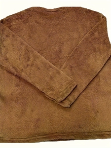 Close-up of the thick brown fleece texture and cuffed sleeve of a warm winter sweatshirt