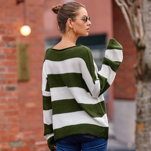 Detailed close-up of green and white striped knit sweater with ribbed crew neck texture