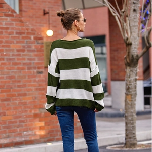 Close-up of green and white striped knit sweater with detailed texture and rolled neckline