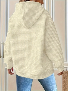 Close-up of white waffle texture hoodie with ribbed cuffs and drop shoulder detail