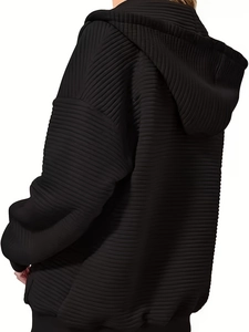 Women's black oversized hoodie featuring unique horizontal pleated texture and a loose fit