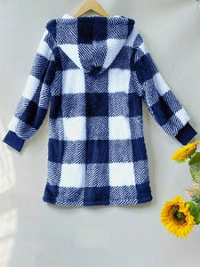Detail of blue and white checkered plush hoodie with ribbed cuffs and soft fleece texture
