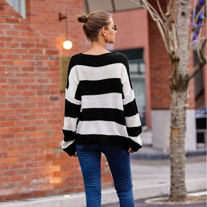 Detail of classic black and white striped knit sweater with round neck and drop shoulders