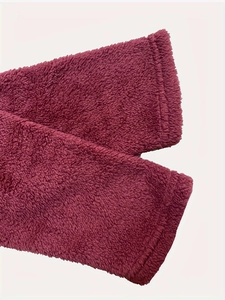 Detailed close-up of dark red fleece fabric cuff with high-density plush texture and stitching