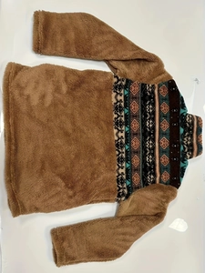 Detail of plush brown fleece sweater with retro geometric pattern patchwork on shoulders