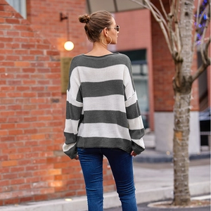 Detail of grey and white striped knit sweater with ribbed crew neck and dropped shoulders
