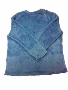 Detail of blue tie-dye plush sweatshirt showing soft fleece texture and crew neck design