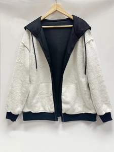 Detailed view of the soft white faux fur texture on a contrast hooded zip-up jacket