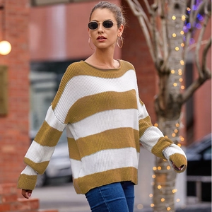 Close-up of ocher and white striped knit texture and rolled crew neck of a cozy sweater