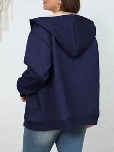 Detail view of navy hooded sweatshirt with cozy beige faux fur lining and knit texture