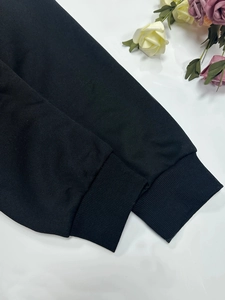 Close-up of black ribbed elastic cuffs on a warm winter fleece hoodie for women