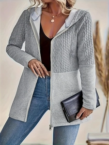 Close-up of light gray zip-up hoodie featuring cable knit textures and patchwork design