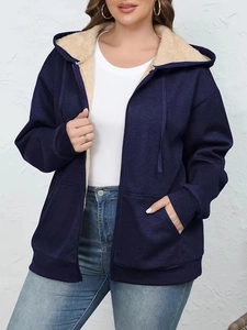Detail of warm navy blue hoodie with contrast sherpa lining and metal zipper closure