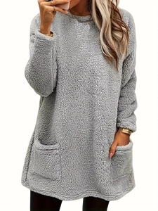 Close-up of soft grey plush hoodie texture featuring symmetrical front pockets