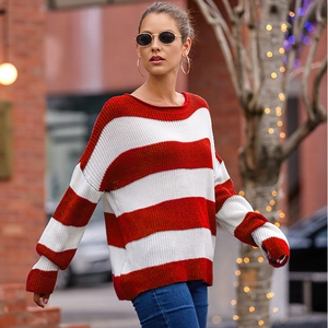 Detail view of red and white striped knit sweater with ribbed cuffs and drop shoulder