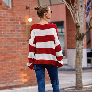 Macro view of textured red and white striped knit sweater with relaxed fit and dropped sleeves