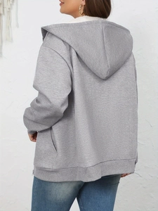 Detail of warm grey hooded sweatshirt featuring soft white faux shearling lining inside