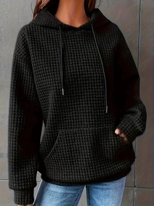 Women's black drawstring hoodie with textured quilted fabric and a relaxed fit