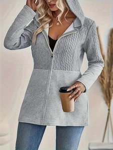Detail of grey hooded jacket featuring cable knit sleeves and smooth texture mix