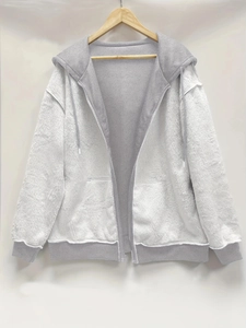 Detail of soft plush fleece hoodie with color-block design and adjustable drawstrings