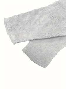 Detail of soft white plush fabric texture and thumb hole design on long sleeve warm top