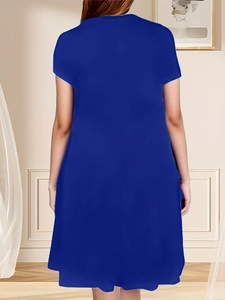 Detail of loose-fit navy blue short sleeve dress showing the back view on a model