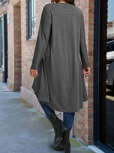 Outdoor street view of a casual dark grey long-sleeve knit cardigan with a slim fit cut