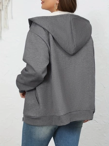 Detail of grey hooded sweatshirt featuring soft white fleece lining and warm texture