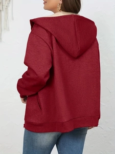 Detail view of burgundy zip-up hoodie featuring warm beige sherpa-lined hood and side pockets