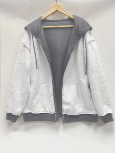 Detail view of heavy fleece zip-up hoodie featuring grey and white colorblock design
