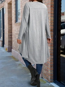 Detail of grey long sleeve cardigan with irregular hem and textured fabric finish