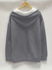 Detailed view of gray hooded sweatshirt with warm white faux fleece lining and ribbed cuffs