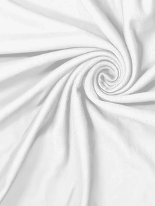 Detailed macro view of soft white microfiber fabric texture in a swirling pattern