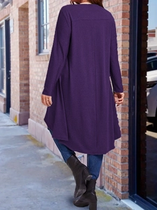 Detail of loose dark purple long cardigan with irregular hem and knit texture finish