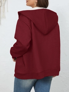 Detail view of burgundy zip-up hoodie featuring warm white faux fur lining and ribbed cuffs