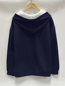 Detail of navy hooded sweatshirt with soft white fleece lining and ribbed cuffs