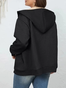 Detail of warm fleece lining and ribbed cuff on a black zip-up hooded sweatshirt