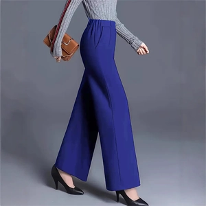 Detail of high-waist navy blue wide-leg trousers with elastic waistband and side pockets