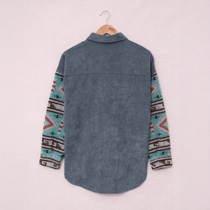 Detail view of corduroy texture and ethnic geometric pattern on long-sleeved shirt jacket