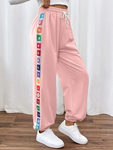 Women's light pink joggers with floral rainbow side stripes and elastic drawstring waist