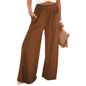 Detail view of high waist brown wide leg trousers with large pockets and elastic waistband