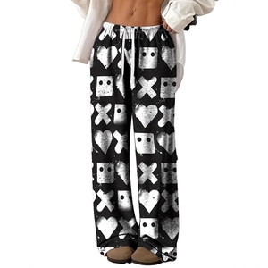Detail of drawstring elastic waistband and graffiti heart print on black wide leg pants